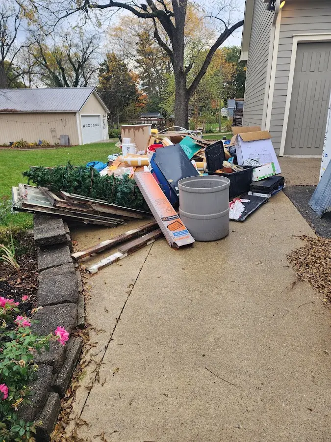 Dumpster being loaded with debris for 12 Yard Dumpster Rental in Snellville